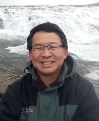 Luke Chung in front of waterfall in Iceland Luke Chung in front of waterfall in Iceland